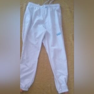 Columbia White Pants With Salmon And teal Accents.